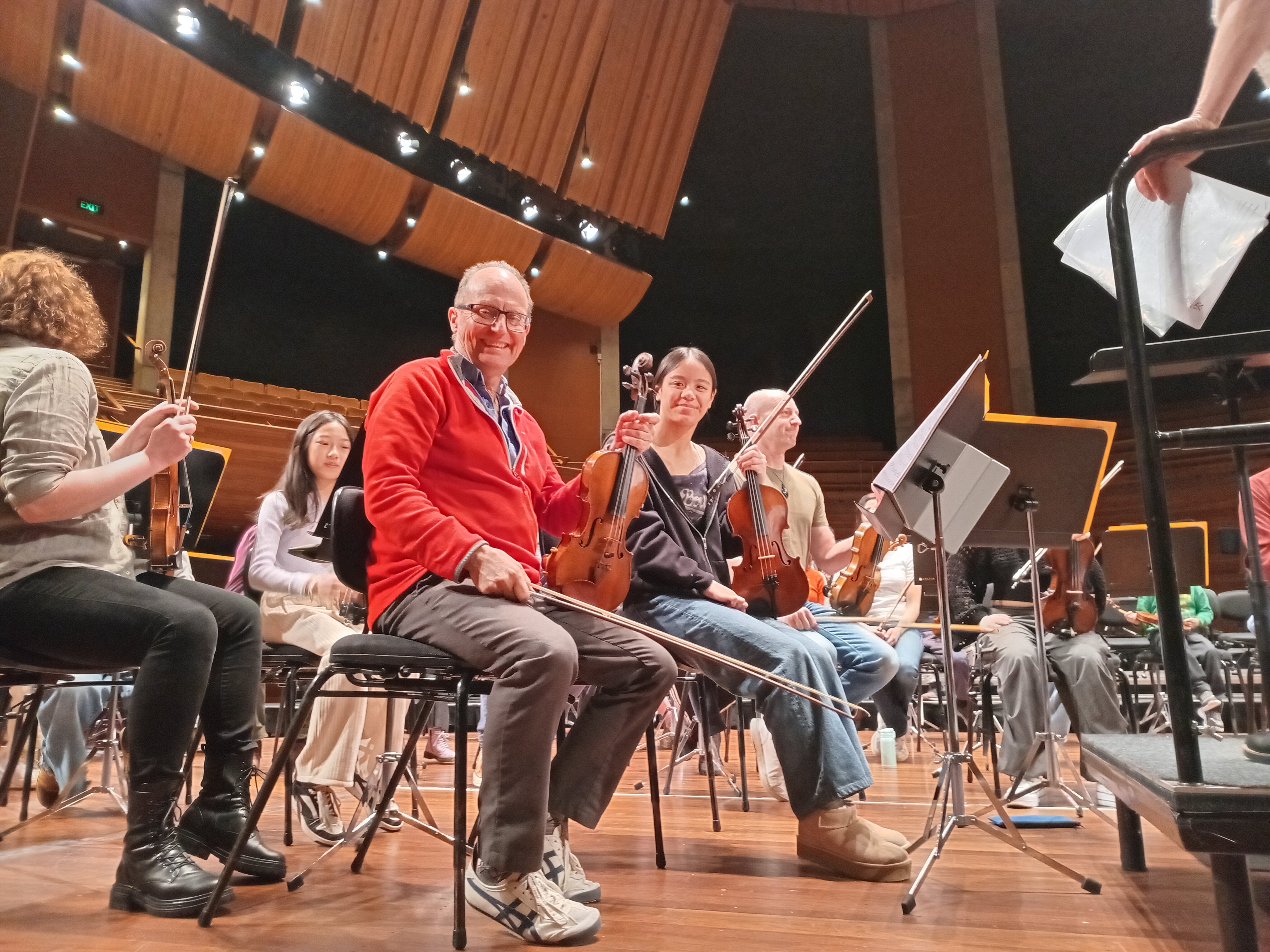 Arohanui Strings+ students playing alongside professional musicians